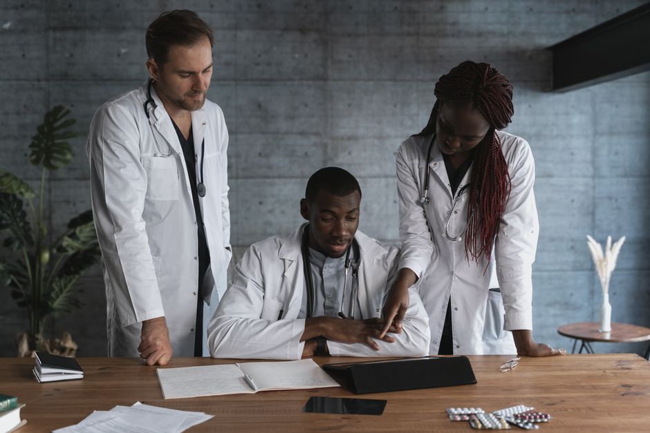 A friendly doctor and a patient looking together at a tablet screen in a bright, modern, and professional clinic office, showing a seamless healthcare experience.