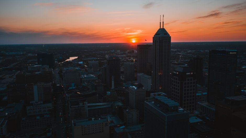 The modern skyline of Indianapolis, Indiana, on a bright, sunny day, symbolizing a forward-thinking city with innovative companies.