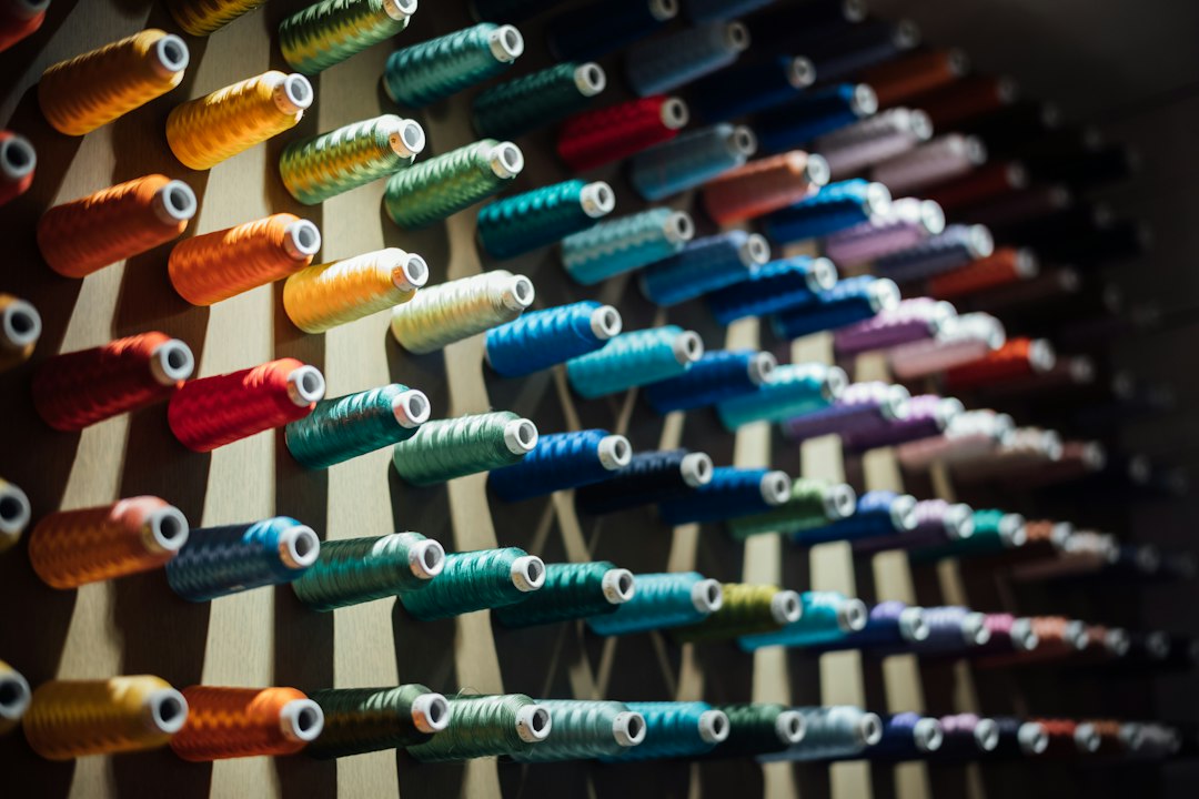 Multiple colorful threads weaving together to form a single, strong strand against a clean background, representing the solution of data integration.