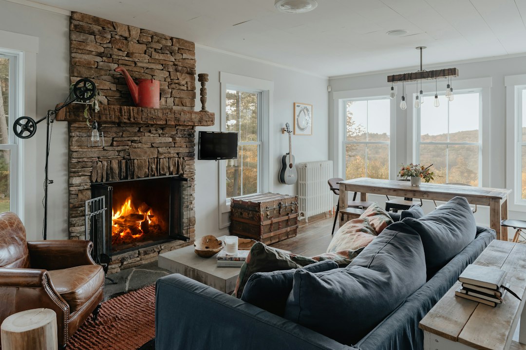 A woman relaxing comfortably in a bright and modern living room, symbolizing the peace and well-being achieved through financial health.